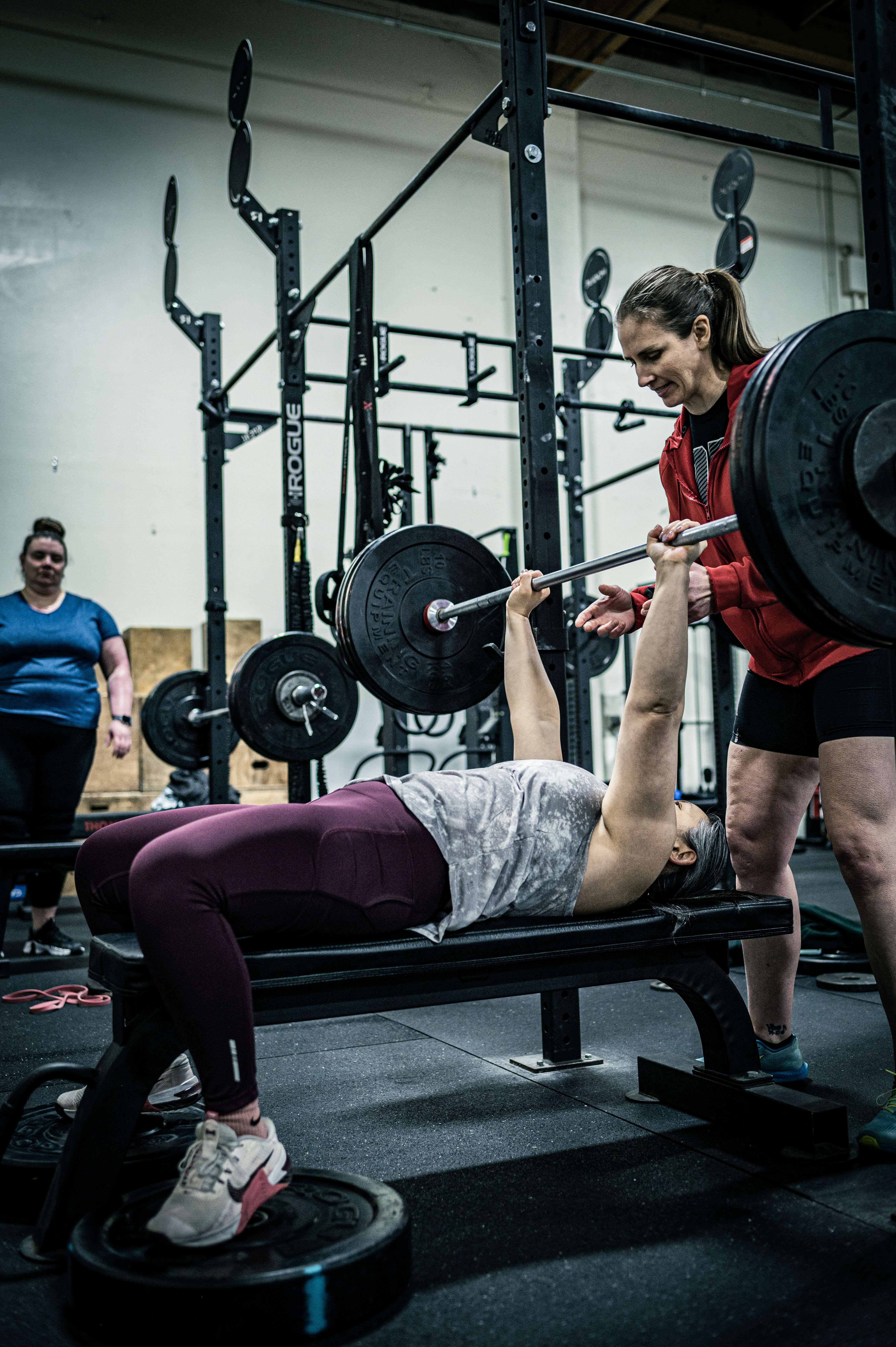 Coach providing one-on-one personal training guidance at CrossFit Tigard