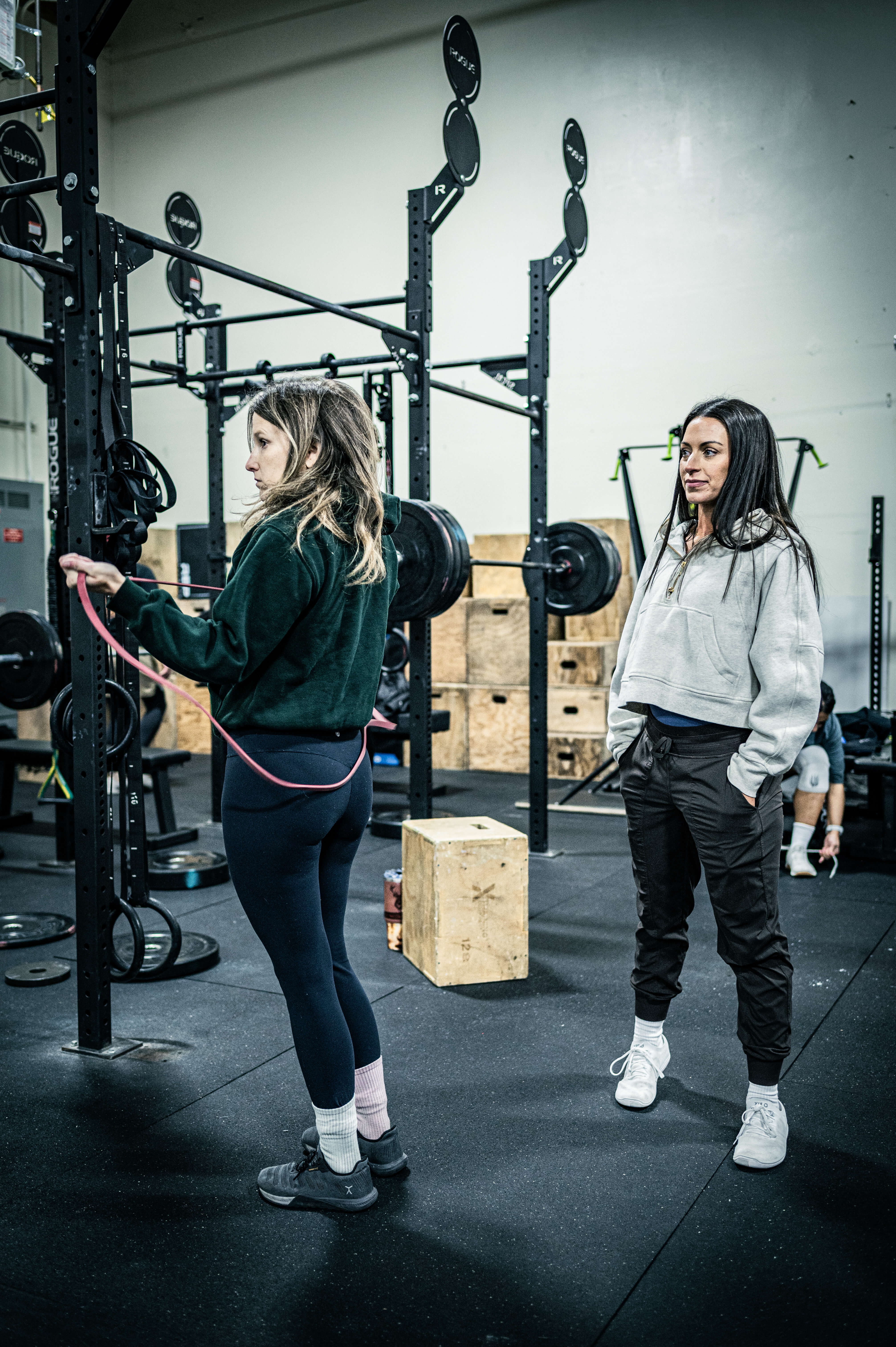 Coach guiding an athlete through barbell training at CrossFit Tigard