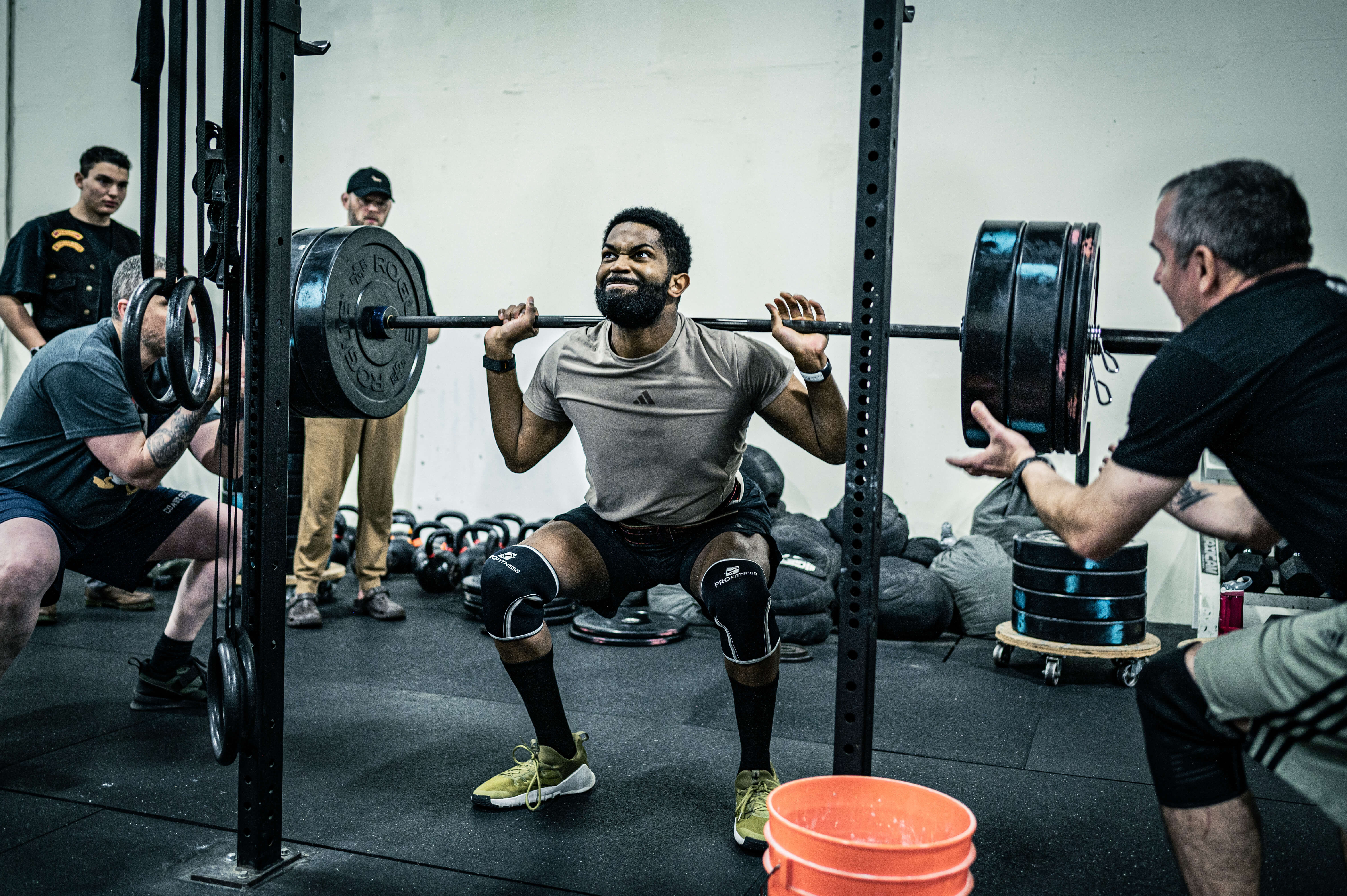 Athlete performing a heavy back squat at CrossFit Tigard competition