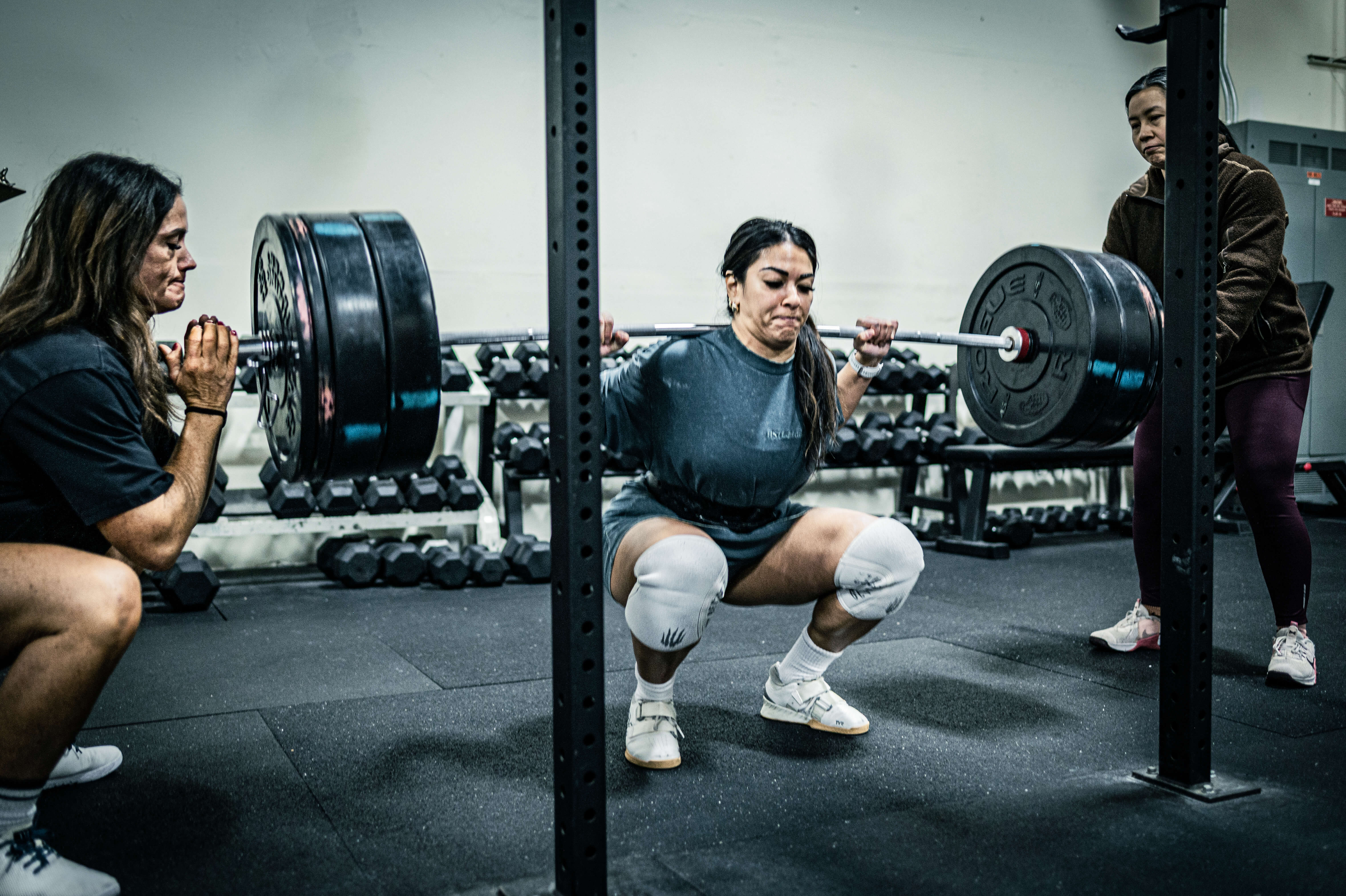 Women supporting each other during heavy squat at CrossFit Tigard